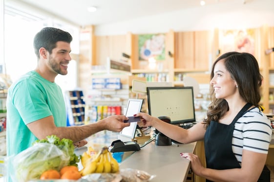 Cashier enrolling a customer into a loyalty program