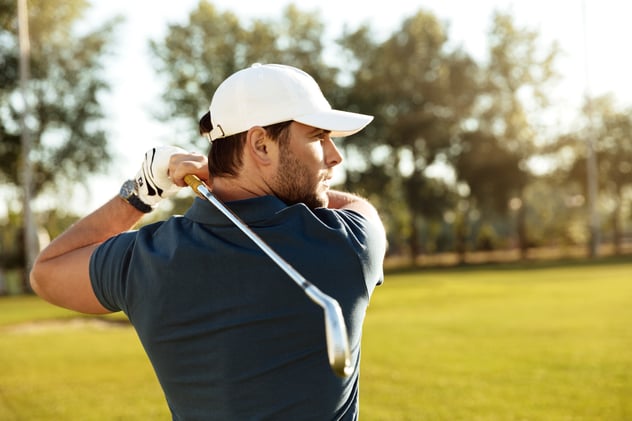 close-up-young-concentrated-man-shooting-golf-ball
