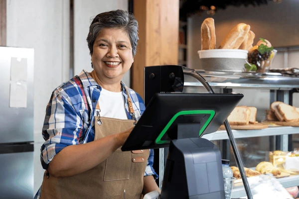 Cashier enrolling customer in loyalty program
