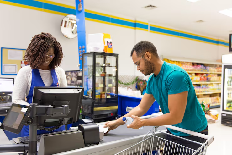 A cashier enrolling a customer in a loyalty program
