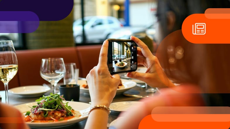 Women taking picture of food at restaurant as user generated content